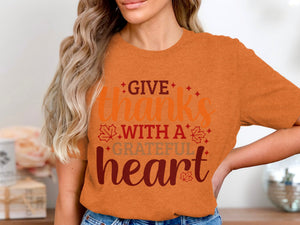 Orange t-shirt with "GIVE thanks WITH A GRATEFUL heart" text and fall leaves.