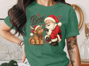 Santa booping a highland cow with "Boop" text and snowflakes.