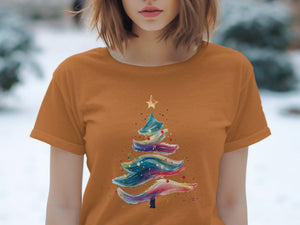 Orange t-shirt with a colorful abstract Christmas tree and star graphic.