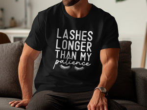 Black t-shirt with white text: "Lashes Longer Than My Patience" and eyelashes.