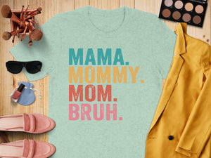 Light blue t-shirt with "MAMA. MOMMY. MOM. BRUH." text in retro colors.