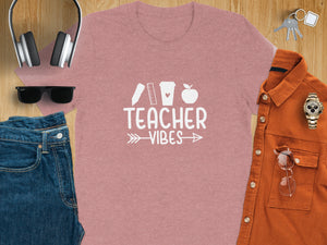Pink t-shirt with "TEACHER VIBES" text and school icons.