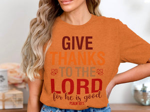 Orange t-shirt with text "GIVE THANKS TO THE LORD for he is good PSALM 107:1"
