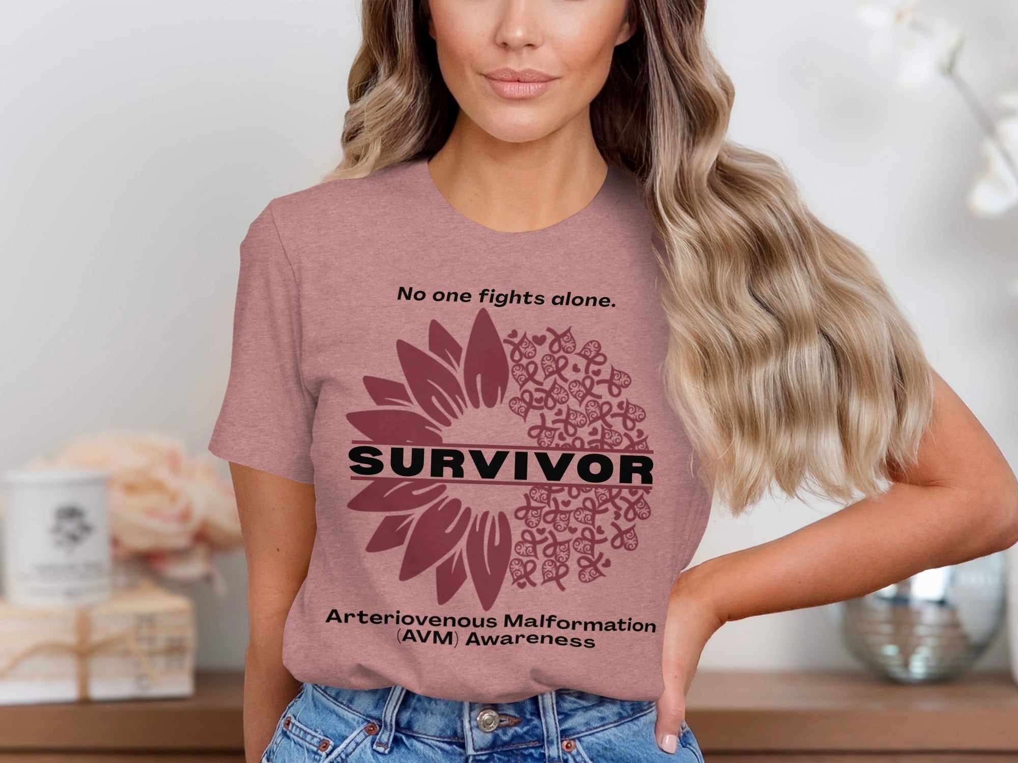 "Survivor" text on t-shirt with sunflower design and "AVM Awareness" quote.