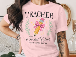 Pink t-shirt with "TEACHER Social Club" text and a pencil graphic.
