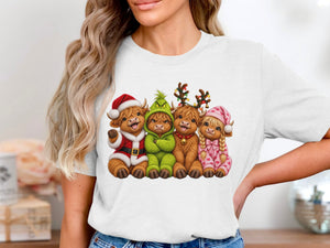 Four fluffy cows dressed for Christmas: Santa, Grinch, reindeer, and pajamas.