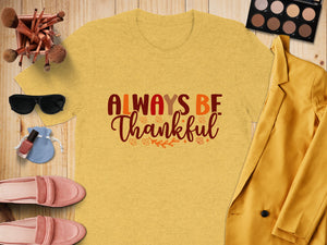 Yellow t-shirt with "Always Be Thankful" text and autumn leaves.