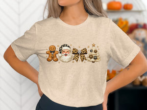 Gingerbread man, Santa, leopard bow, and Christmas tree graphic on a light t-shirt.