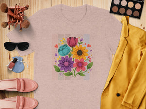 Pink t-shirt with a colorful floral bouquet graphic and surrounding accessories.