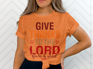 Orange t-shirt with text: GIVE THANKS TO THE LORD for he is good, PSALM 107:1