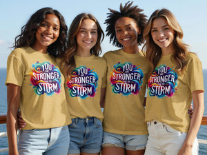 Four women wear gold t-shirts with "You Are Stronger Than The Storm" graphic.