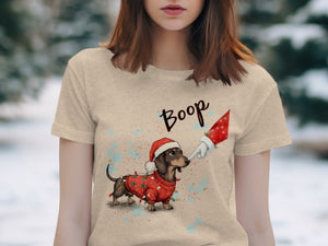 Dachshund wearing Santa hat and Christmas lights sweater with "Boop" text.
