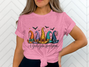 Pink t-shirt with five colorful witch hats and text that reads "A Girl's Gotta Have Options".