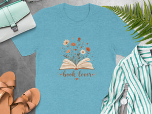 Teal t-shirt with open book and "book lover" text with floral accents.