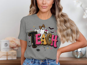 Ghost with leopard print bow holding coffee cup on grey t-shirt with word "TEACH".