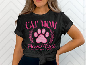 Black t-shirt with pink text and a cat paw print reading "Cat Mom Social Club".