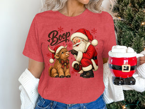 Santa booping a highland cow with "Boop" text on a red shirt.