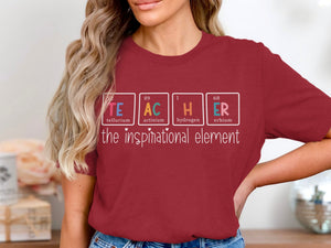 Maroon t-shirt with "TEACHER" spelled using periodic table elements: "TE," "AC," "H," "ER."