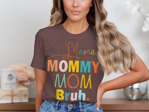 Brown t-shirt with colorful text "Mama Mommy Mom Bruh" on a woman.