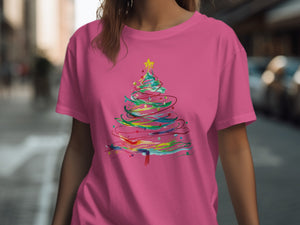 Pink t-shirt with a colorful, abstract Christmas tree graphic.