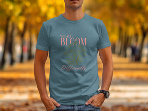 Teal t-shirt with "We All Bloom Differently" text and botanical graphic.