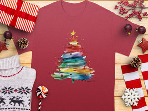 Maroon t-shirt with colorful watercolor Christmas tree graphic and festive decorations.