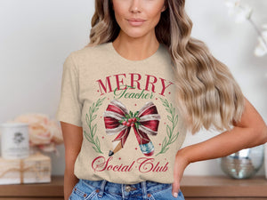 Cream t-shirt with "Merry Teacher Social Club" text and Christmas graphics.