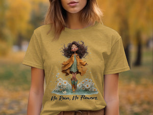 Yellow t-shirt with graphic of girl in raincoat and boots among daisies and text "No Rain, No Flowers."