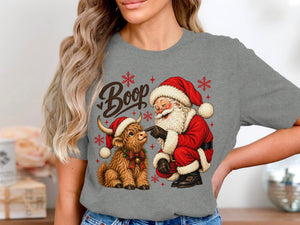 Santa booping a Highland cow with "Boop" text and snowflakes.