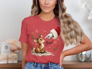 Santa's hand boops a reindeer's nose on a red t-shirt.