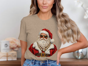 Santa Claus illustration wearing sunglasses and a diamond necklace on a taupe t-shirt.