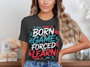 Dark grey t-shirt with "Born to Game Forced to Learn" graphic in white, blue, and red.