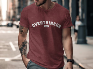 Maroon t-shirt with white distressed text "OVERTHINKER 24/7" worn by a man.