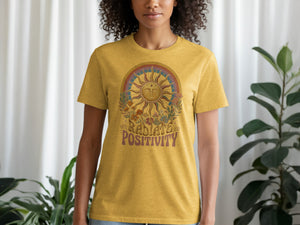 Yellow t-shirt with sun, flowers, and text that reads "RADIATE POSITIVITY".