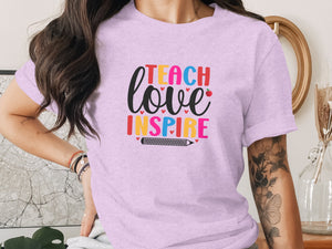 Light purple t-shirt with colorful text "TEACH love INSPIRE" and pencil graphic.