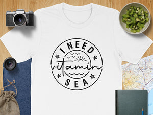 White t-shirt with "I NEED vitamin SEA" graphic in a circle.