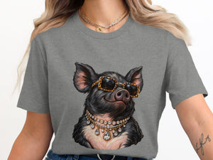 Pig with sunglasses and diamond necklaces printed on a gray t-shirt.