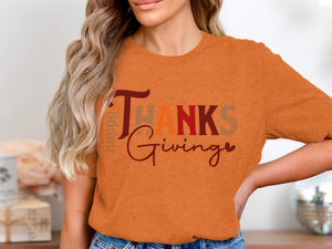 Orange t-shirt with "Happy Giving" text in autumn colors.