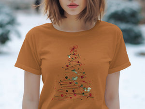 Orange t-shirt with a watercolor-style Christmas tree design featuring ornaments and holly.