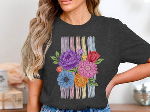Dark t-shirt with a colorful floral bouquet design over pastel vertical stripes.