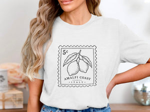 White t-shirt with a postage stamp graphic featuring lemons and "Amalfi Coast Italy".