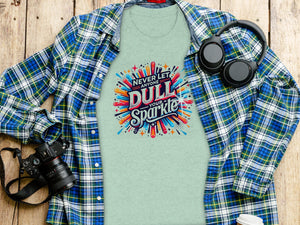 Green t-shirt with "Never let anyone dull your sparkle" graphic, plaid shirt, headphones, and camera.