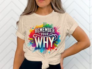 T-shirt with text "Remember Your Why" amid colorful paint splashes.