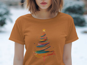 Orange t-shirt with a colorful, abstract Christmas tree graphic and a yellow star.