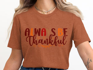Orange t-shirt with "Always Be Thankful" text and fall leaf graphics.