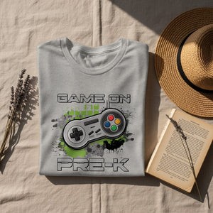 Gray t-shirt with "GAME ON PRE-K" text and video game controller graphic.