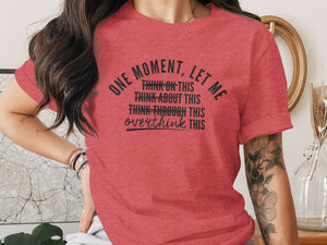 Red t-shirt with black text reading "ONE MOMENT, LET ME THINK ON THIS THINK ABOUT THIS THINK THROUGH THIS overthink THIS".