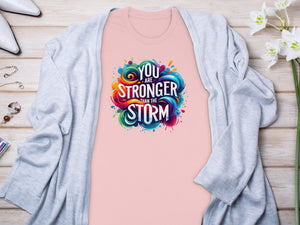 Pink t-shirt with "You are stronger than the storm" graphic