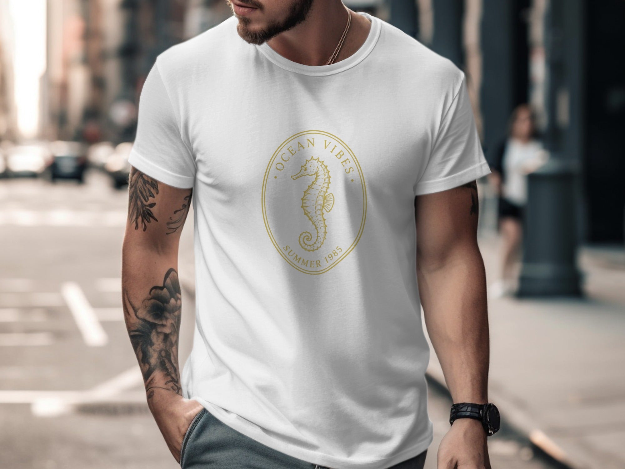 White t-shirt with gold oval graphic of seahorse and text "OCEAN VIBES SUMMER 1985".