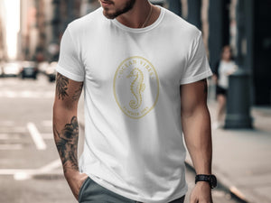 White t-shirt with gold oval graphic of seahorse and text "OCEAN VIBES SUMMER 1985".